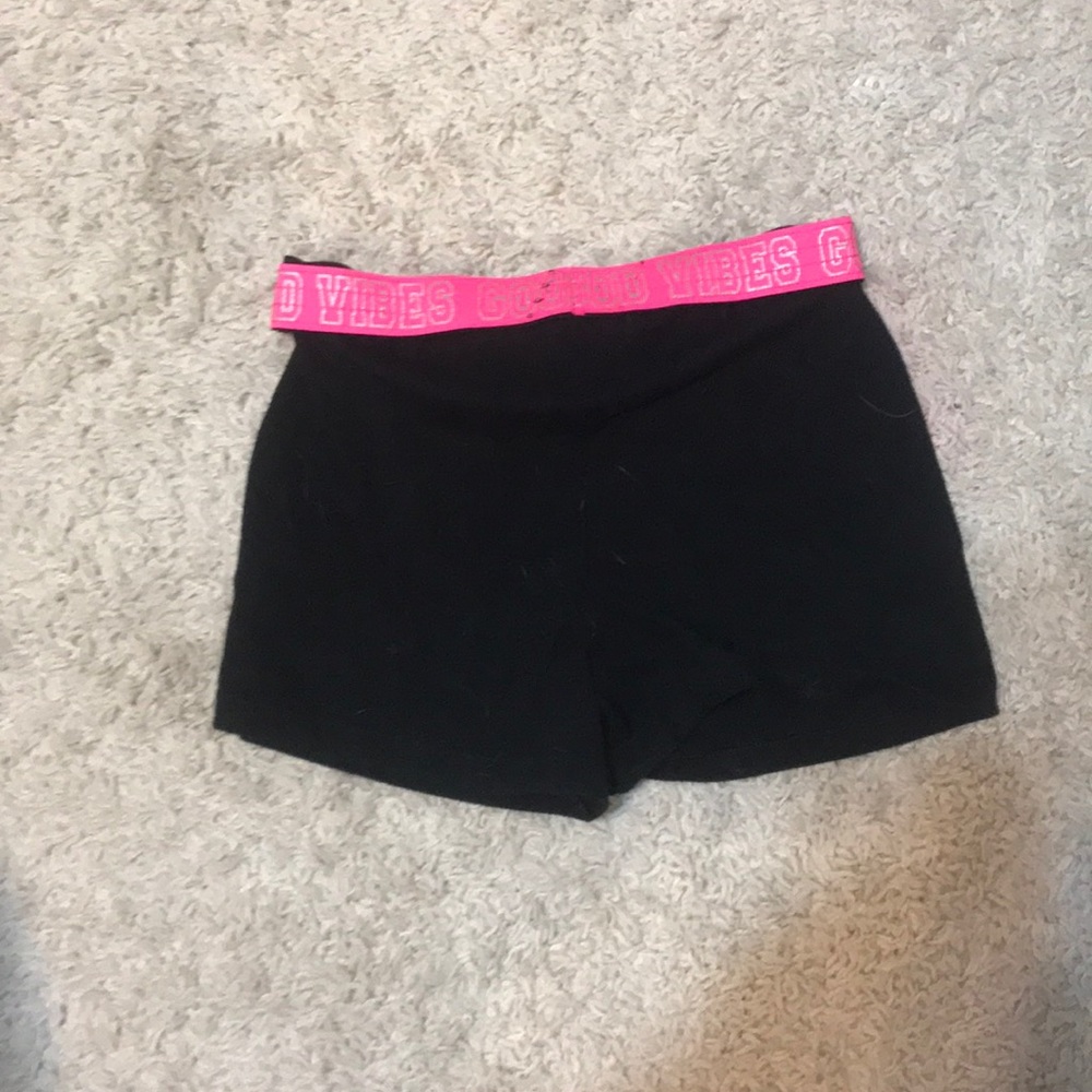Black shorts with a pink band and are a size 10-12